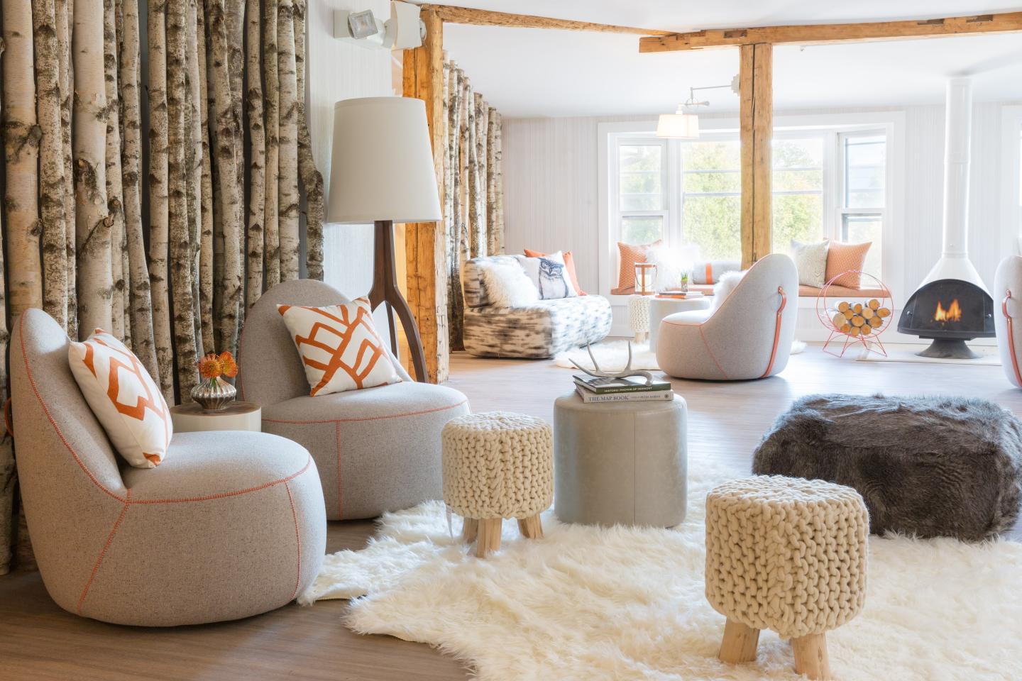 Cozy living room with modern furniture, birch accents, and soft lighting.