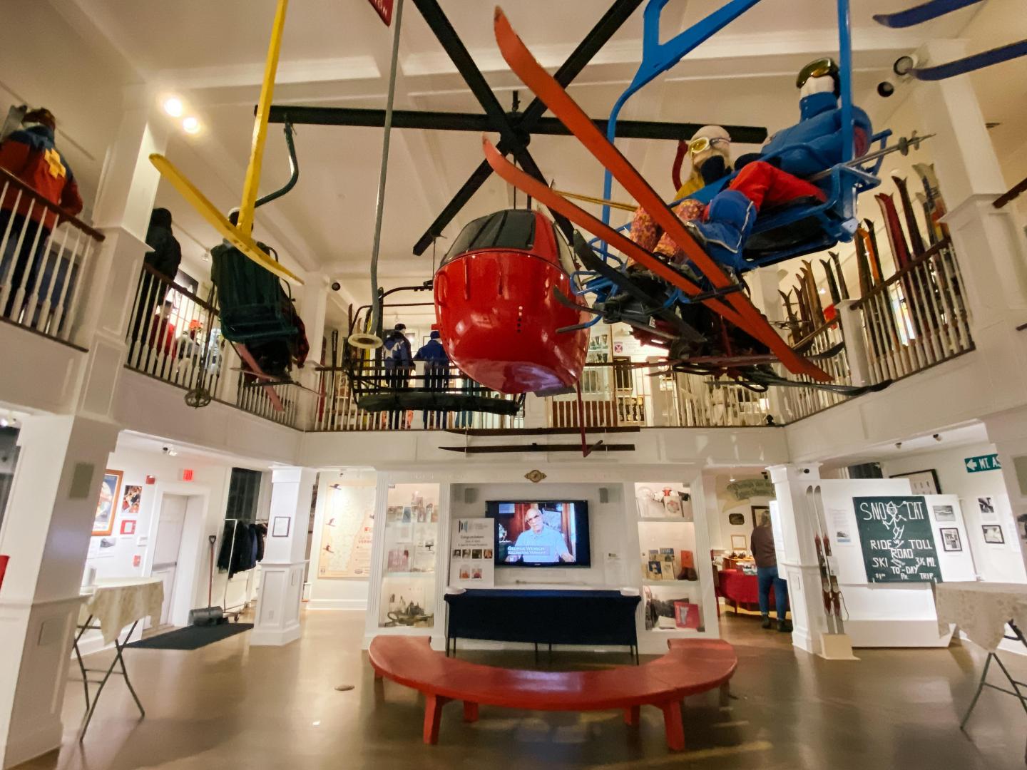 Ski museum interior with colorful equipment on display.
