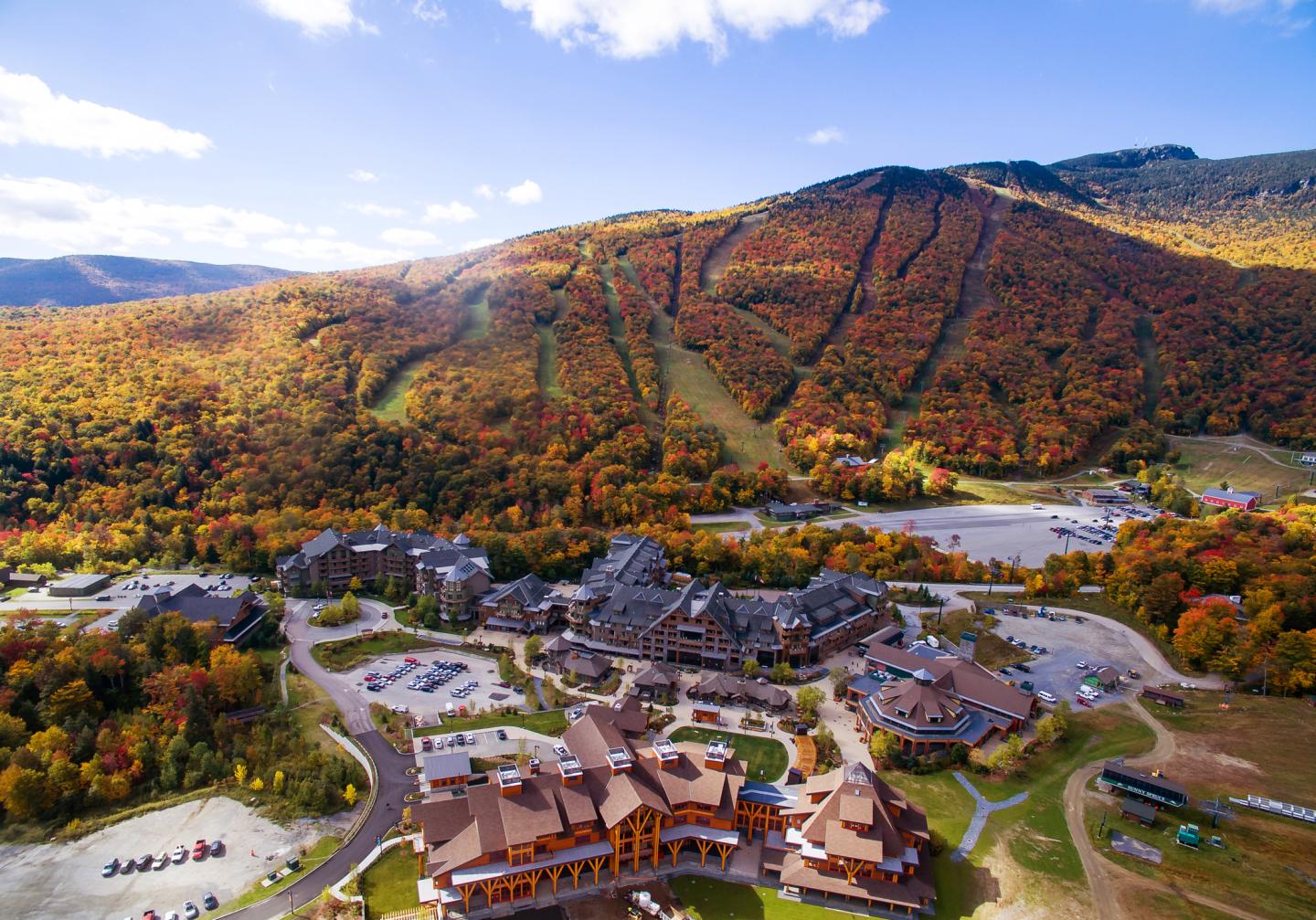 Mountain resort in autumn with colorful foliage and clear blue sky.