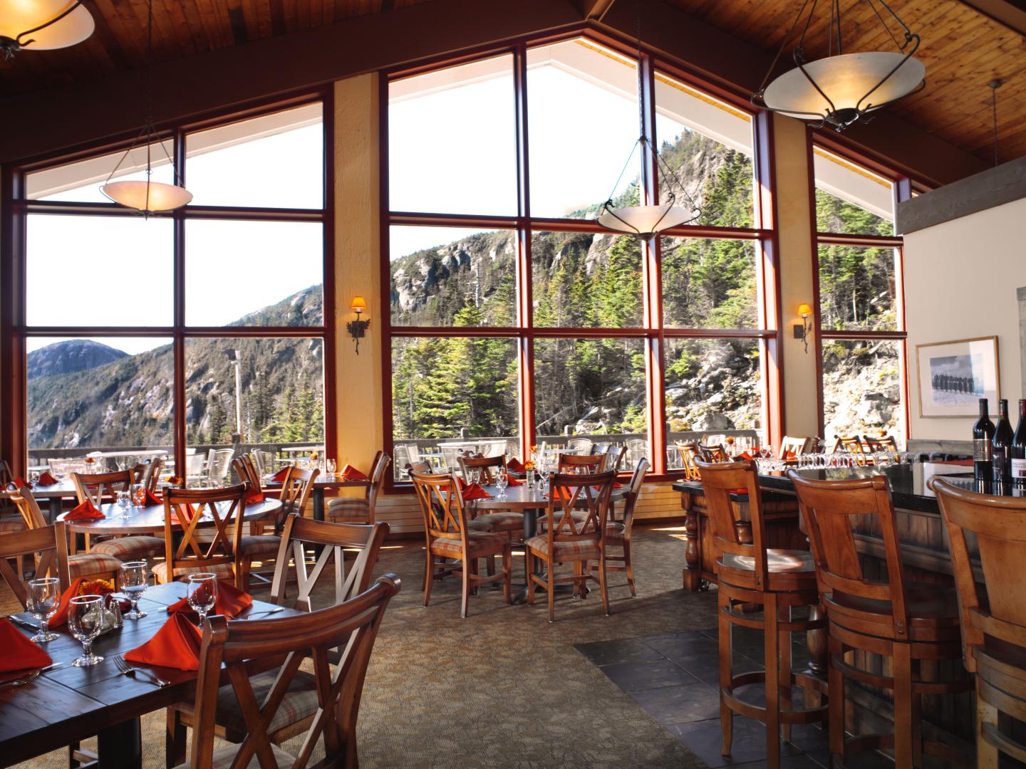 Restaurant with large windows and mountain view.