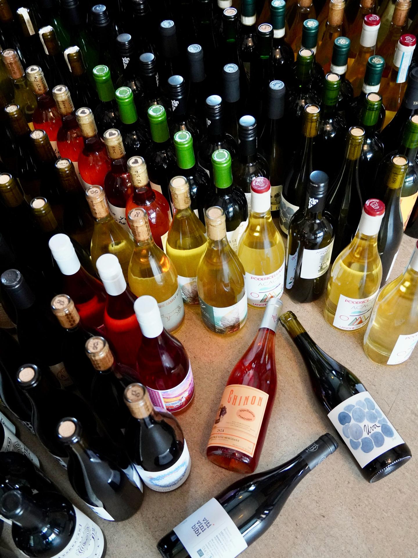 Assorted wine bottles arranged on a flat surface.