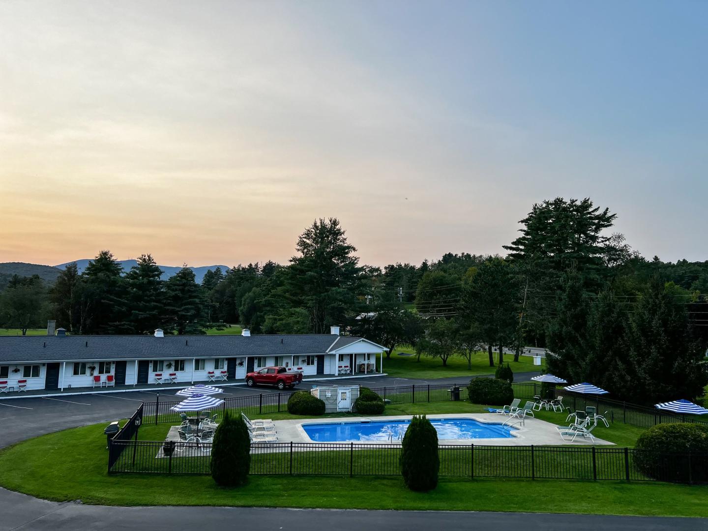 Stowe Motel exterior photo during a sunset with pool