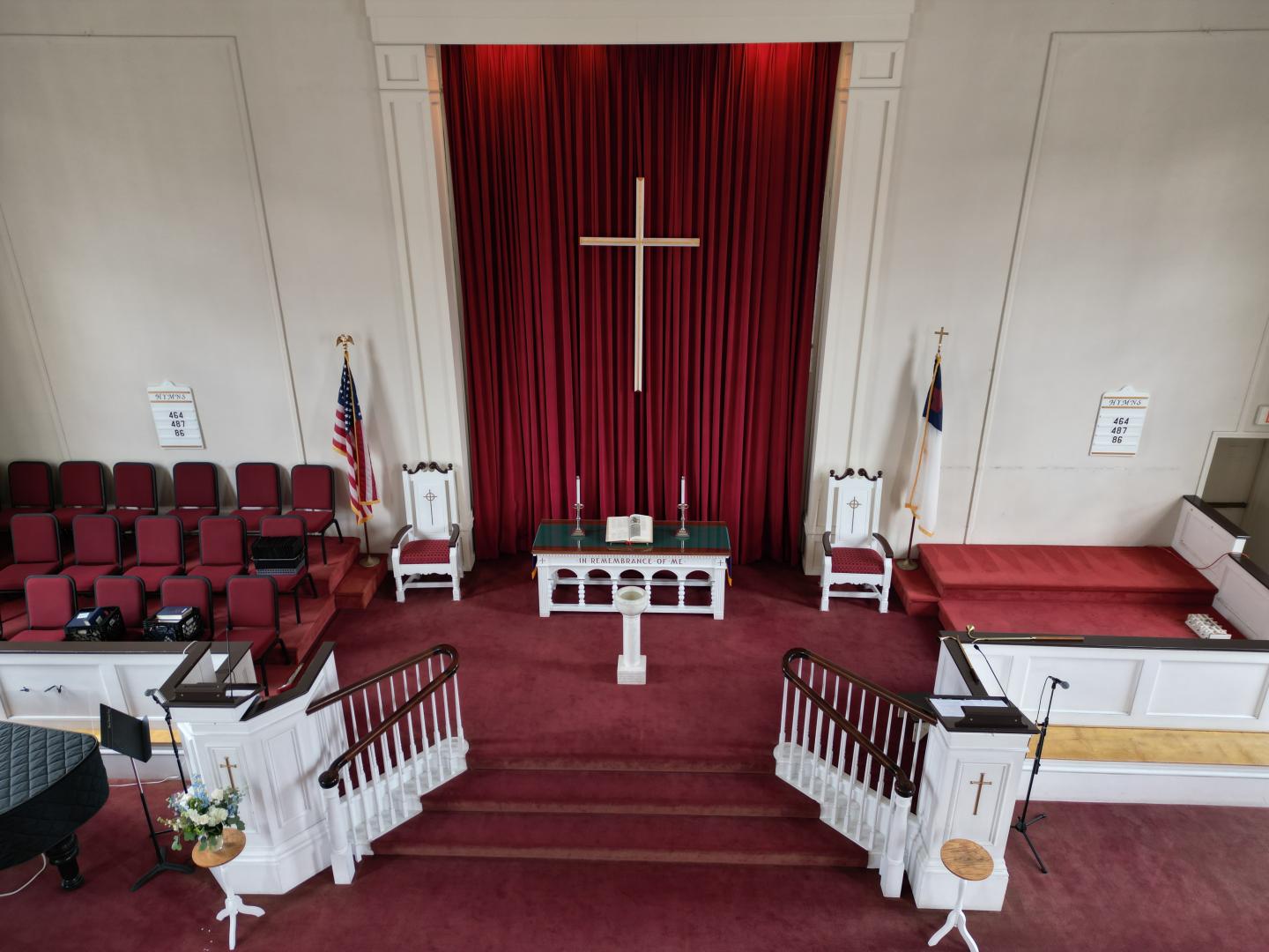 Church interior with red carpet, large cross, and altar.