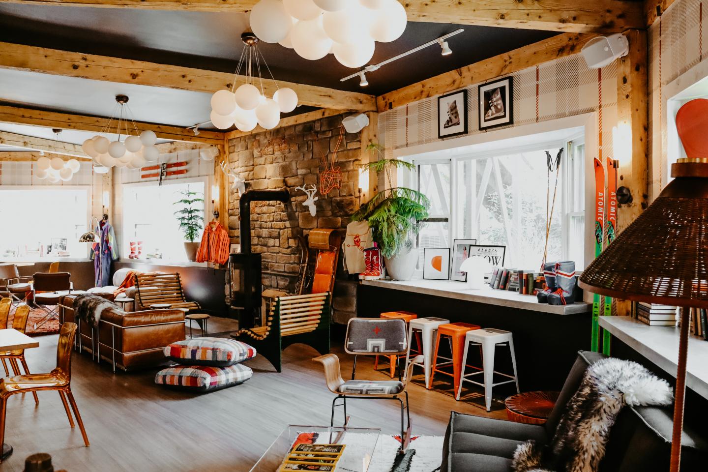 Cozy, eclectic living room with wooden beams, sofas, and colorful decor.