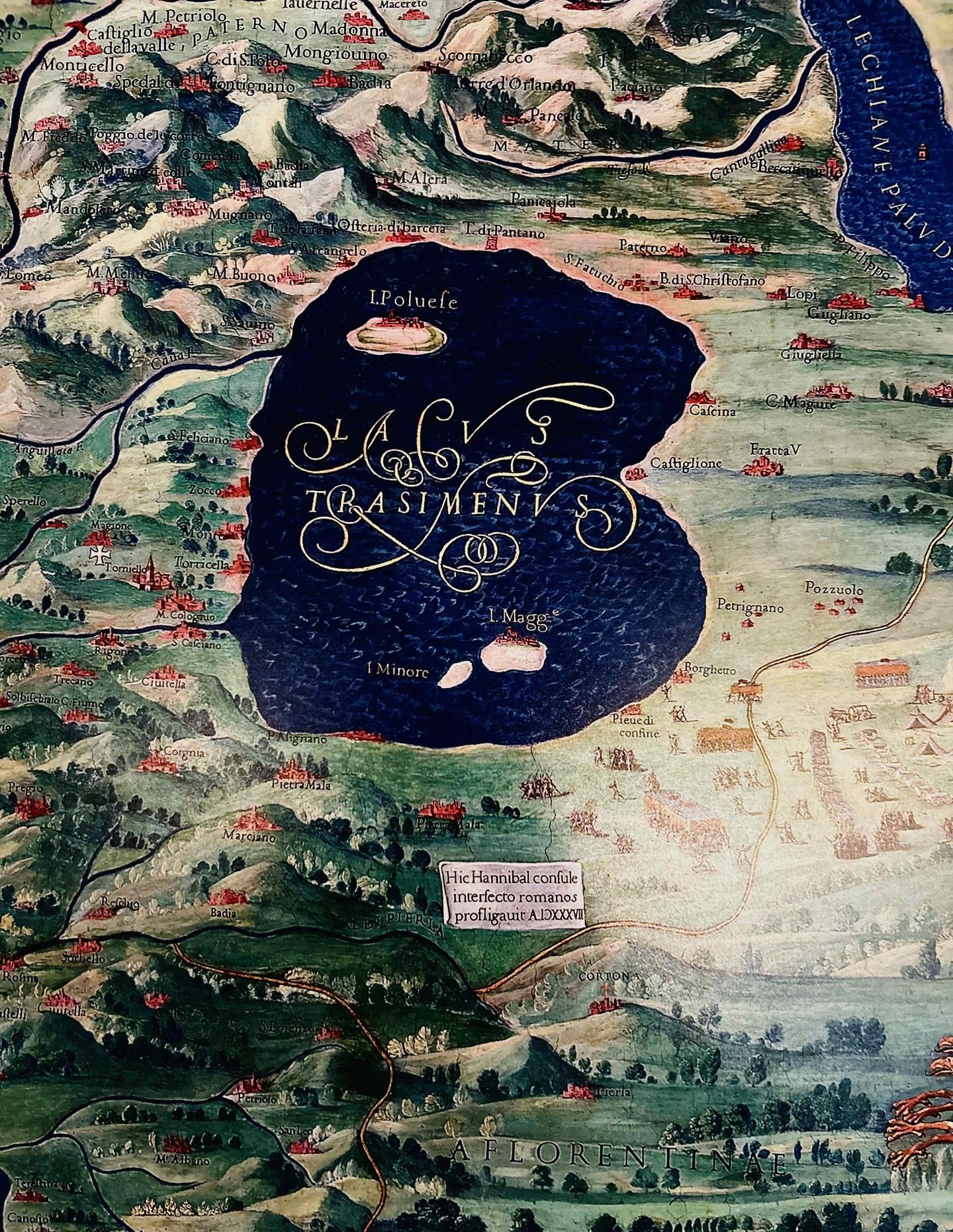 Ornate historical map depicting a large dark blue lake and surrounding landscape.