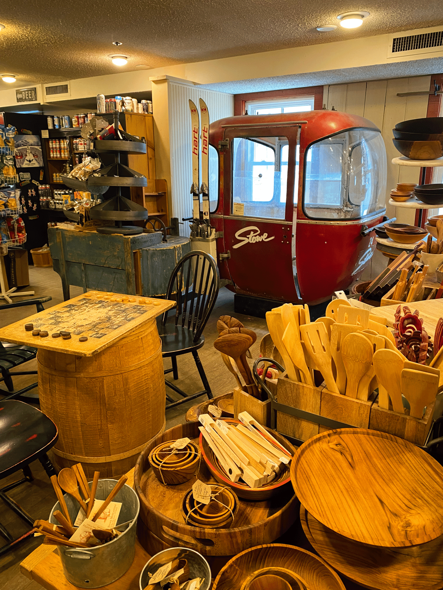 Antique store with a red gondola, wooden items, and various collectibles.