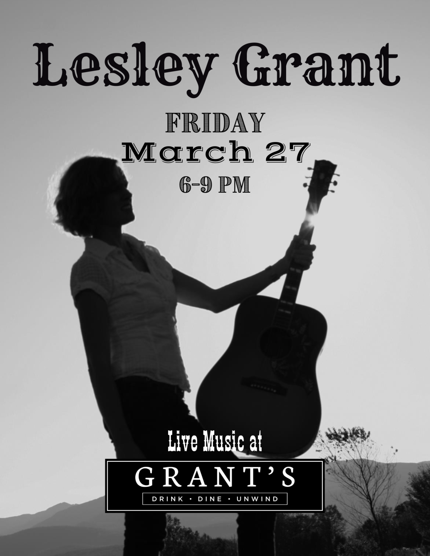 Silhouette of a person holding a guitar in black and white.