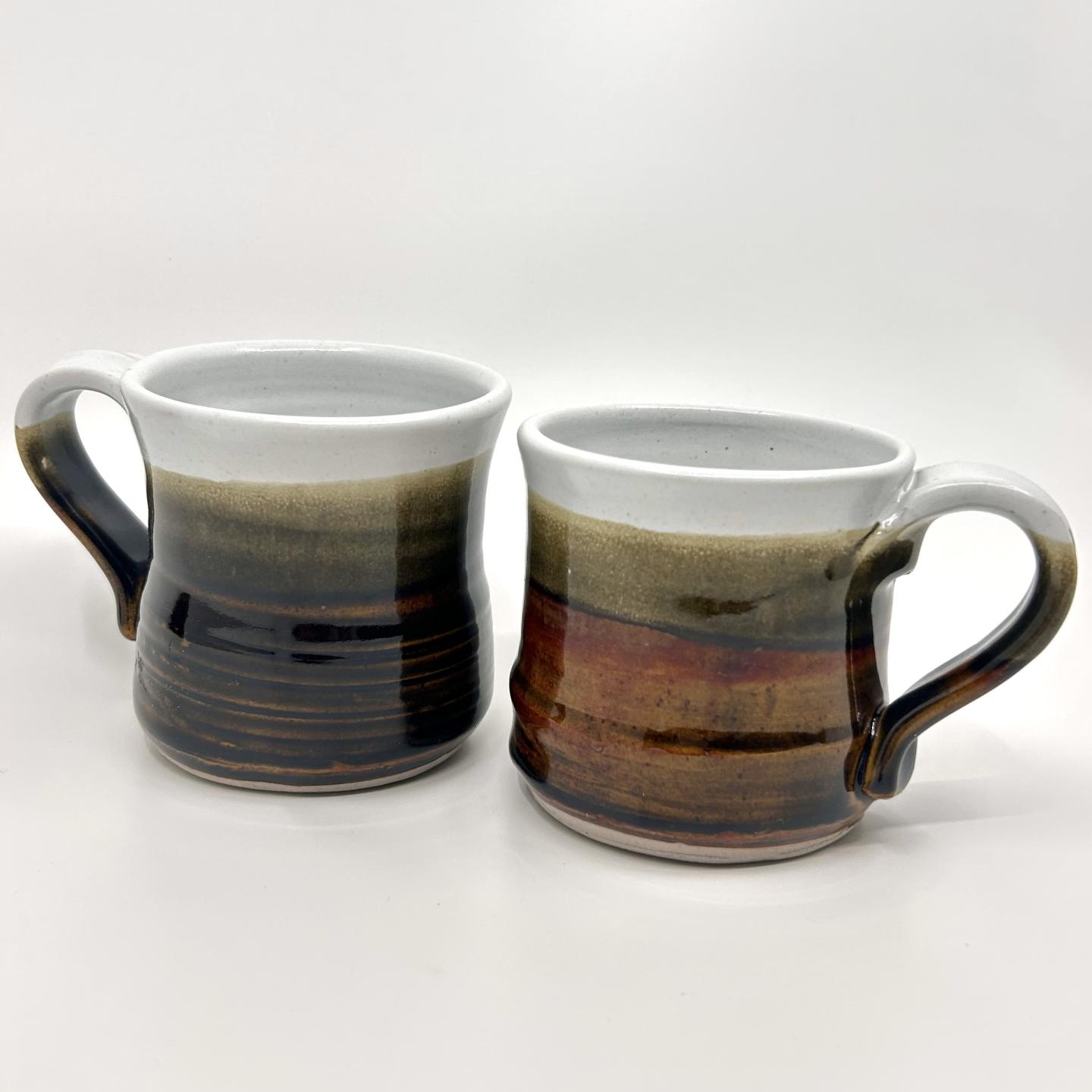 Ceramic mugs with brown and green gradient glaze.