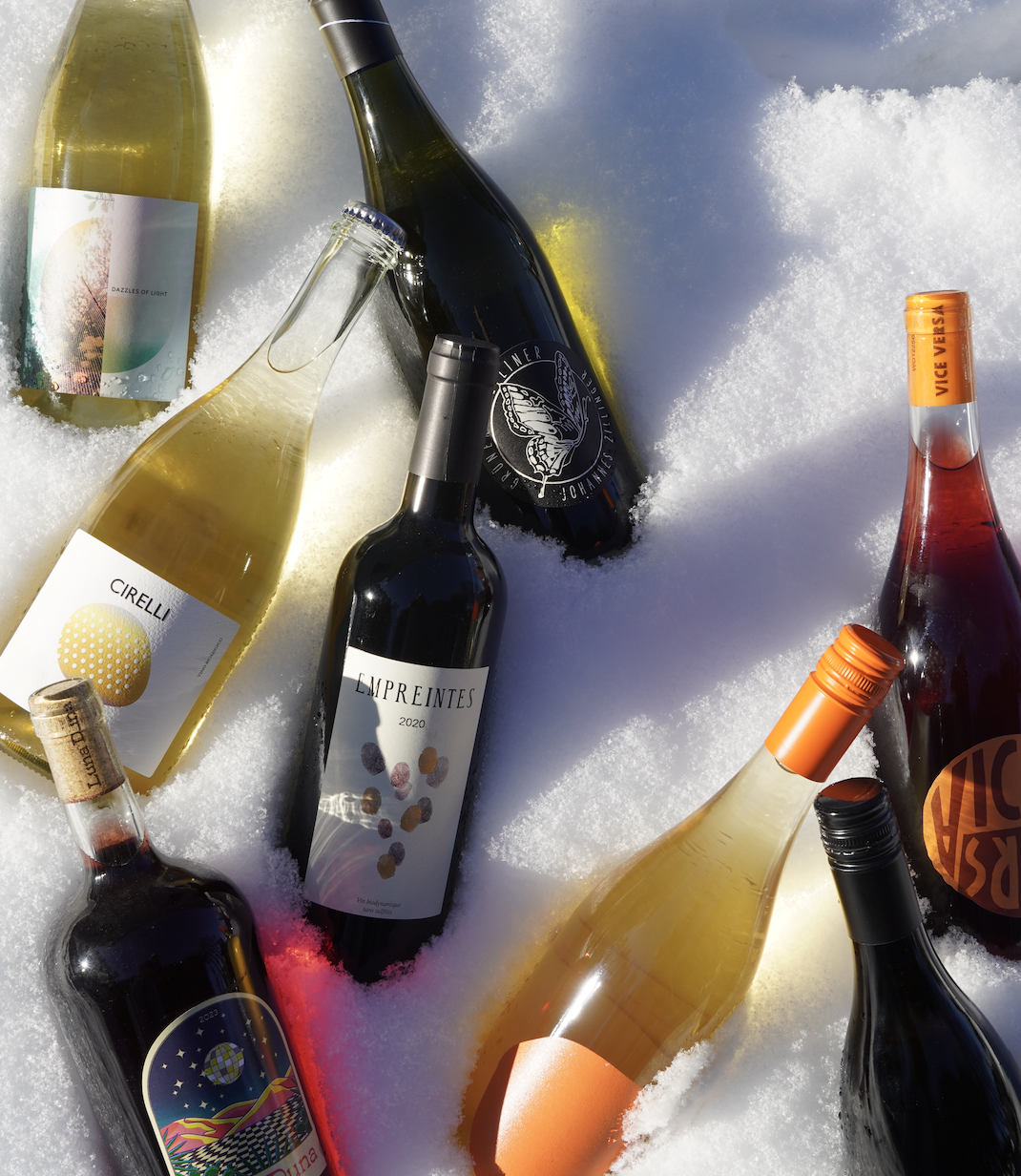 Wine bottles chilling in the snow.