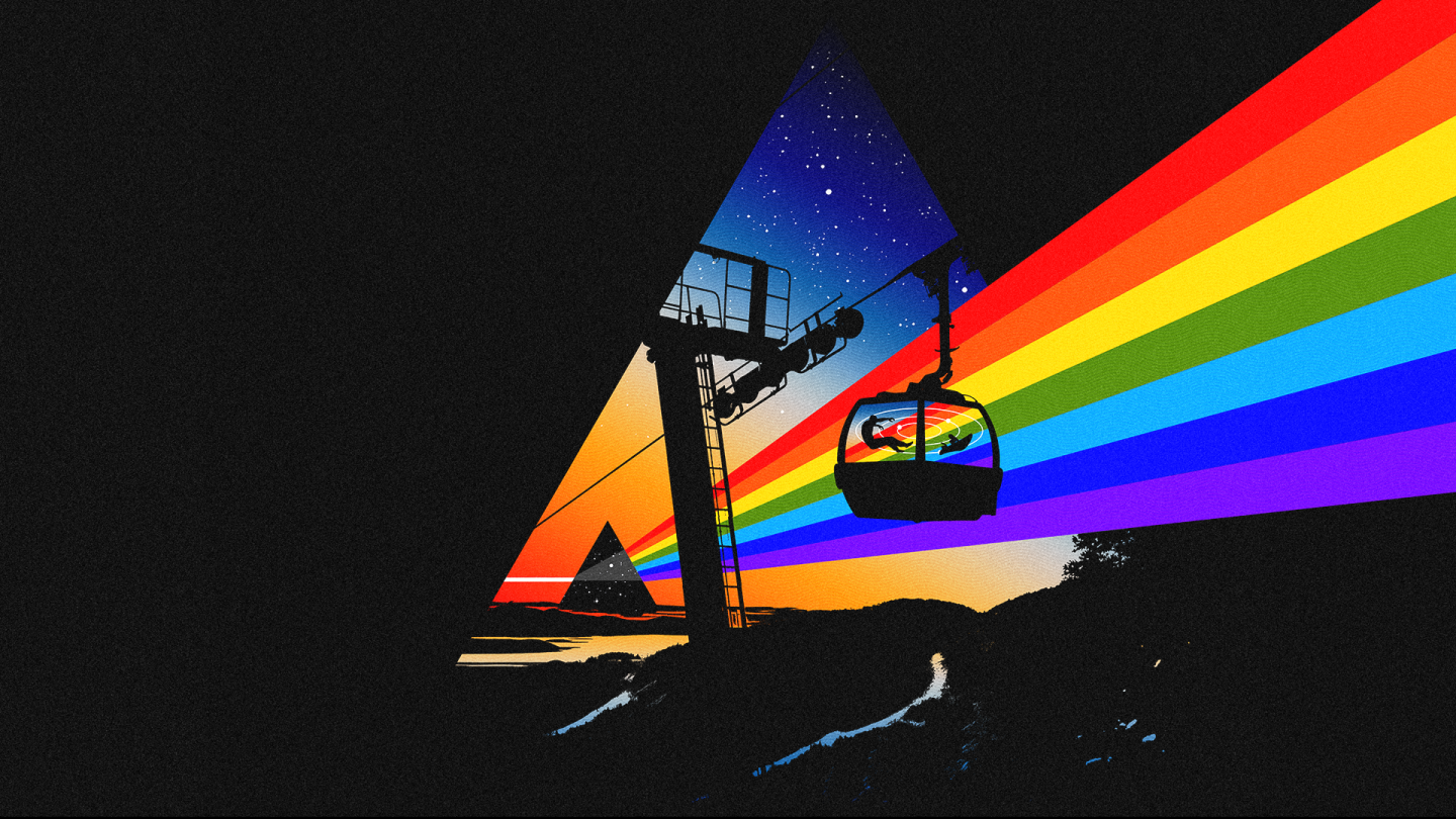 Cable car casting rainbow light through a triangular night sky.
