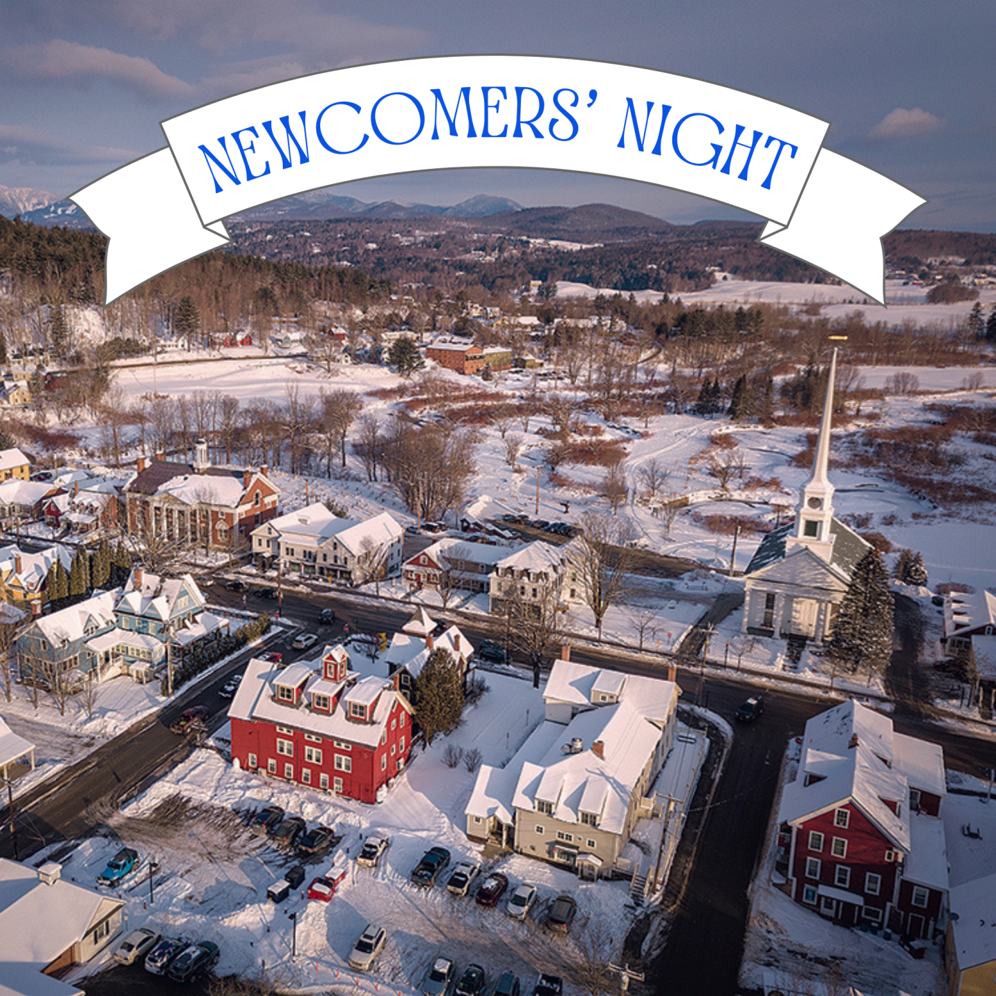 Aerial view of a snowy village with a church and colorful buildings.