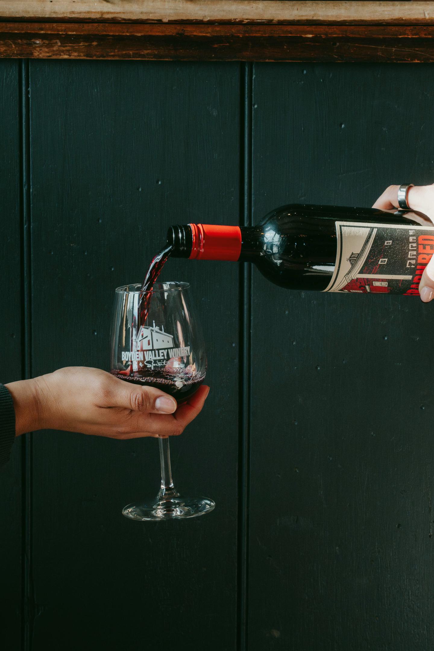 Pouring Boyden Valley Big Barn red wine into a glass