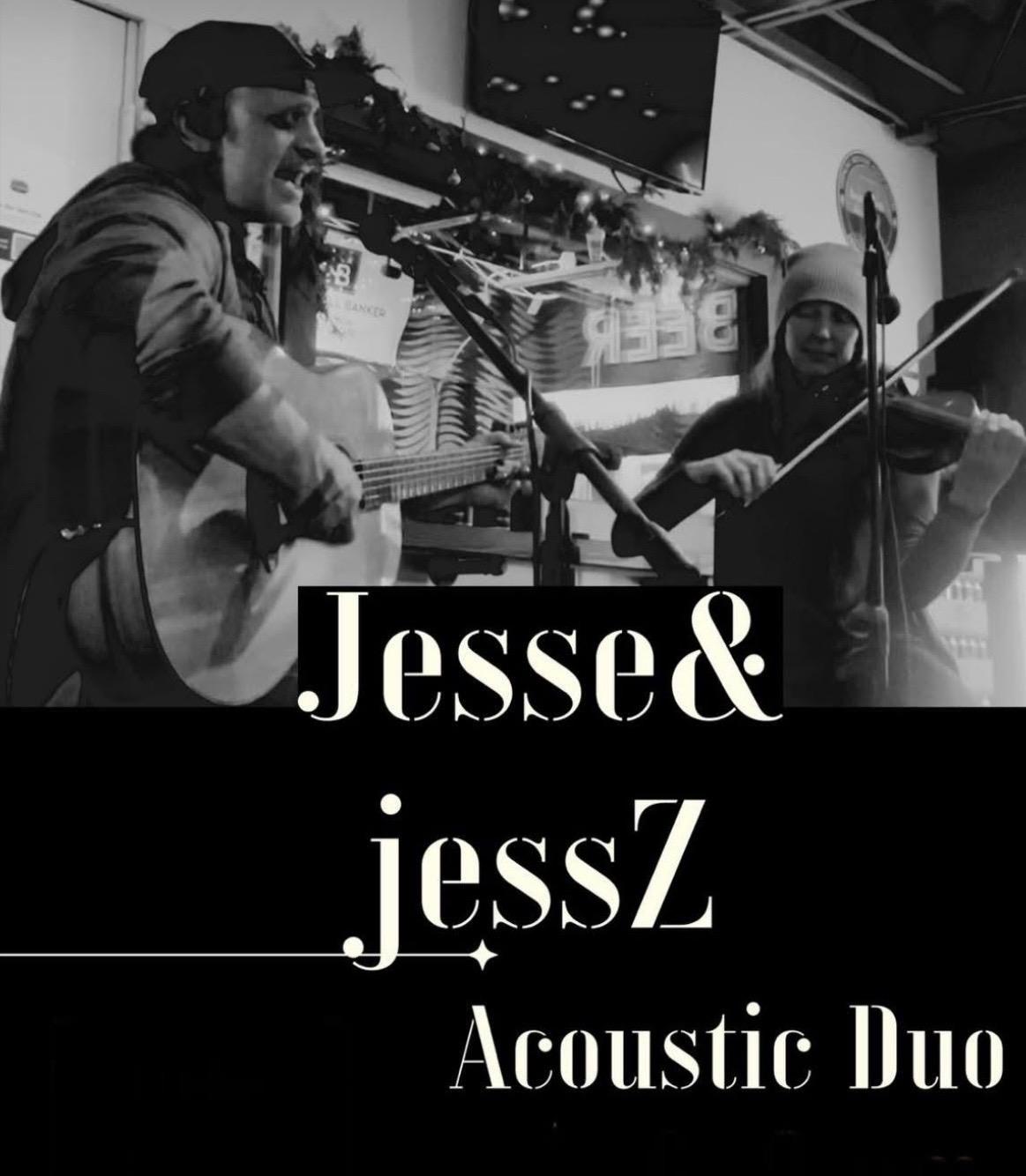 Acoustic duo performing on stage, guitarist and violinist.